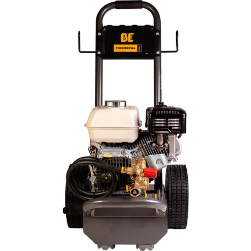 A commercial-grade pressure washer with a gasoline engine, featuring a black frame, gray tank, beige fuel container, and black wheels, shown against a plain white background.